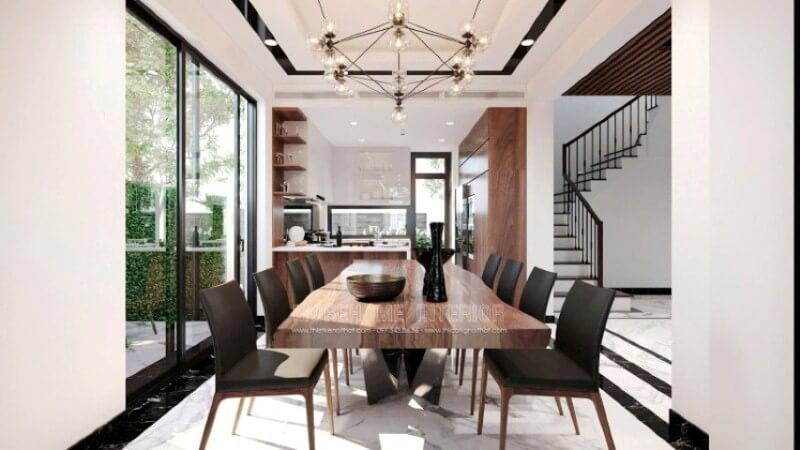 Không chỉ là nơi để mọi thành viên trong gia đình thưởng thức những tinh hoa ẩm thực, mà còn là nơi để gia đình vun đắp nên mái ấm hạnh phúc. Do đó, việc trang trí, lựa chọn đồ nội thất phù hợp với lối sống, gu thẩm mỹ và bố trí ánh sáng của gia đình là rất quan trọng. Tùy từng cá tính của mỗi gia đình mà sẽ có những ý tưởng thiết kế nội thất phòng ăn khác nhau. Ví dụ như ý tưởng thiết kế nội thất phòng ăn phong cách hiện đại trong biệt thự Vinhomes Imperia Hải Phòng. Chất liệu gỗ óc chó tự nhiên được thể hiện liền mạch dọc tầm nhìn, chiếc bàn gỗ óc chó nguyên khối, mẫu ghế bọc da sử dụng khung gỗ óc chó, dóng sang hai bên là tủ bếp gỗ óc chó, cùng kệ để đồ bắt mắt.
